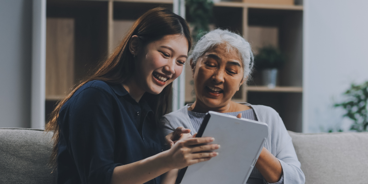 Two people engaging with a tablet.